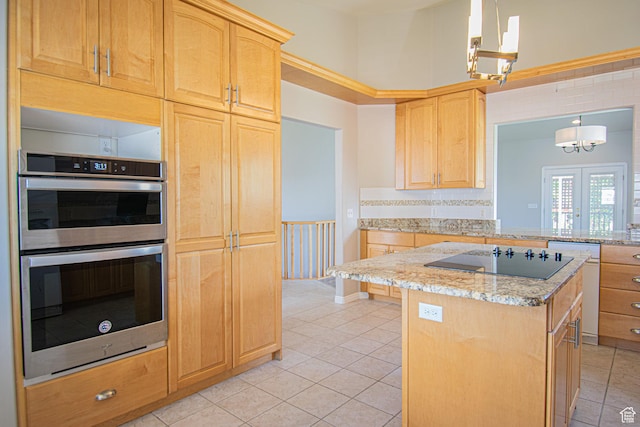 584 S Oak Ln, Tooele, UT 84074 - kitchen with stainless steel double oven, black electric stovetop, light brown cabinets, and light tile patterned floors