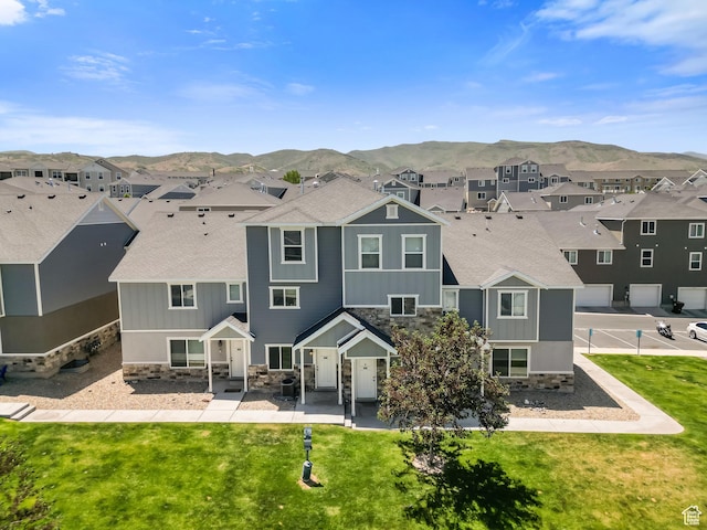 14391 S Oakfield Way, Herriman, UT 84096 - back of property featuring stone siding, a residential view, a mountain view, and board and batten siding