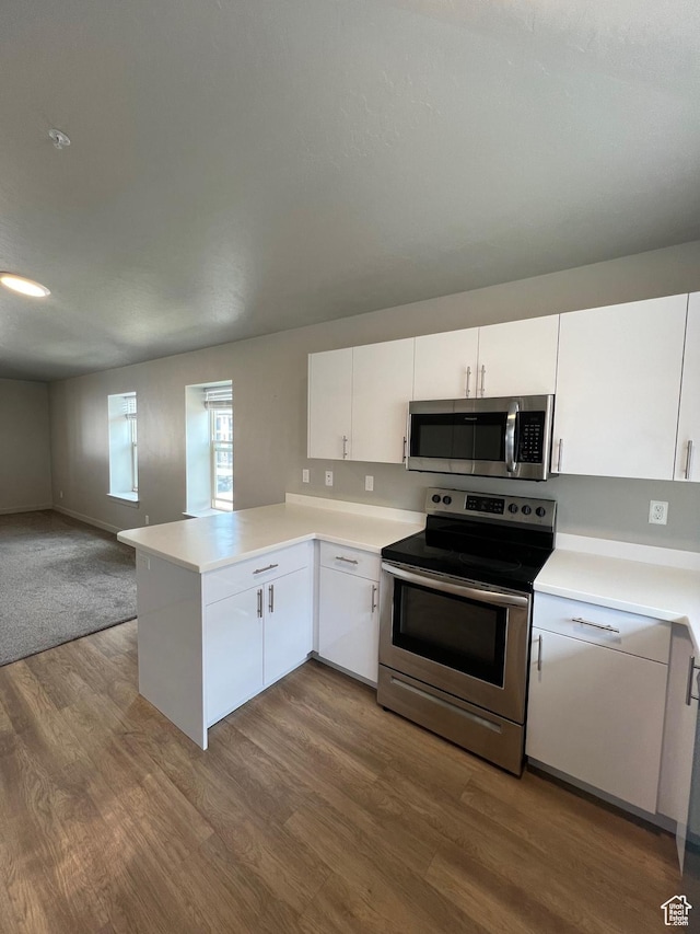 1140 W 950 N Unit C401, Orem, UT 84057 - kitchen featuring stainless steel appliances, dark wood finished floors, open floor plan, and white cabinets