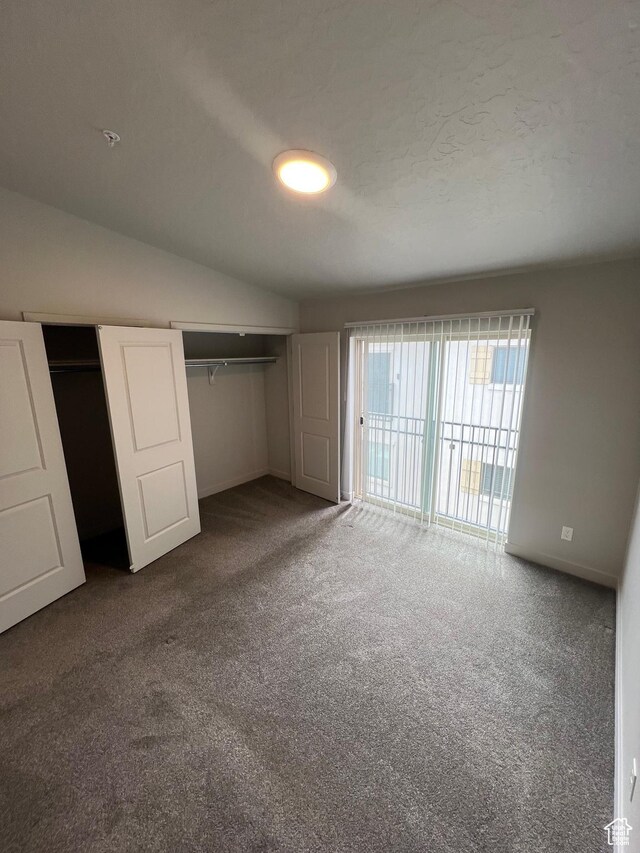 1140 W 950 N Unit C401, Orem, UT 84057 - unfurnished bedroom with carpet, multiple closets, baseboards, access to outside, and vaulted ceiling