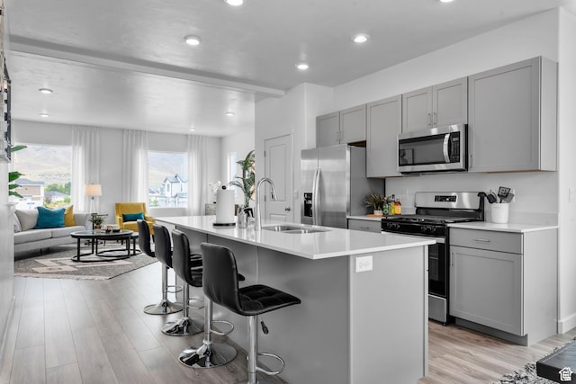 1906 E Thunder Ln Unit 507, Eagle Mountain, UT 84005 - kitchen featuring stainless steel appliances, gray cabinets, a sink, light wood finished floors, and recessed lighting