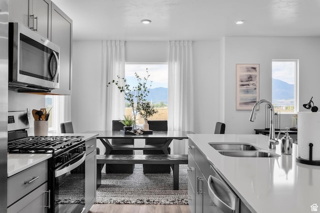1897 E Thunder Ln Unit 498, Eagle Mountain, UT 84005 - kitchen featuring stainless steel appliances, a sink, gray cabinets, healthy amount of natural light, and recessed lighting