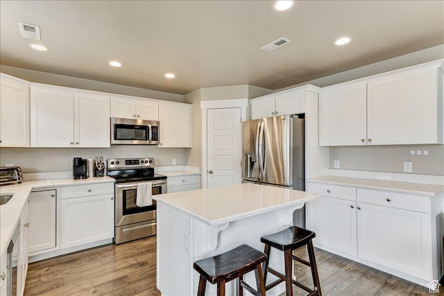399 N 1325 W, Springville, UT 84663 - kitchen featuring appliances with stainless steel finishes, light wood-type flooring, white cabinets, and recessed lighting