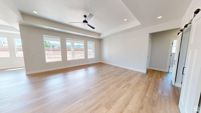 1151 S 4475 W, Cedar City, UT 84720 - spare room featuring a tray ceiling, a barn door, a ceiling fan, light wood-style floors, and recessed lighting