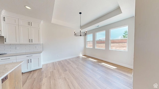 1151 S 4475 W, Cedar City, UT 84720 - unfurnished dining area featuring a raised ceiling, light wood-style floors, baseboards, a chandelier, and recessed lighting