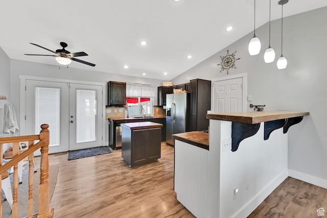 3926 W 5100 S, Roy, UT 84067 - kitchen with stainless steel refrigerator with ice dispenser, a sink, a center island, light wood-style flooring, and a ceiling fan