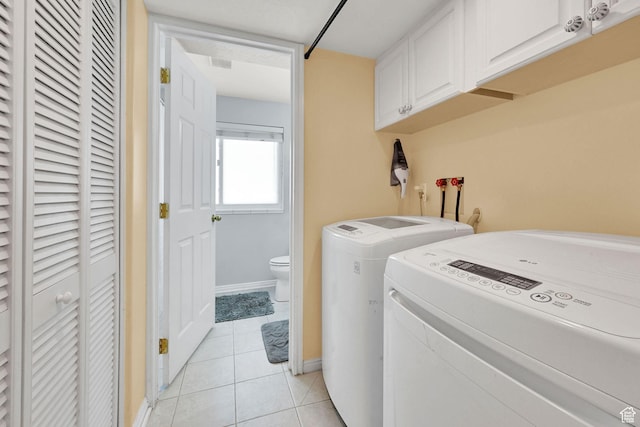 3926 W 5100 S, Roy, UT 84067 - washroom featuring washer and clothes dryer, light tile patterned flooring, cabinet space, and baseboards