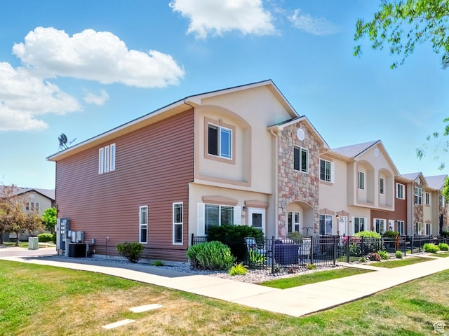 1587 N 565 W Unit 101, Logan, UT 84341 - view of side of home featuring stone siding, stucco siding, and a residential view