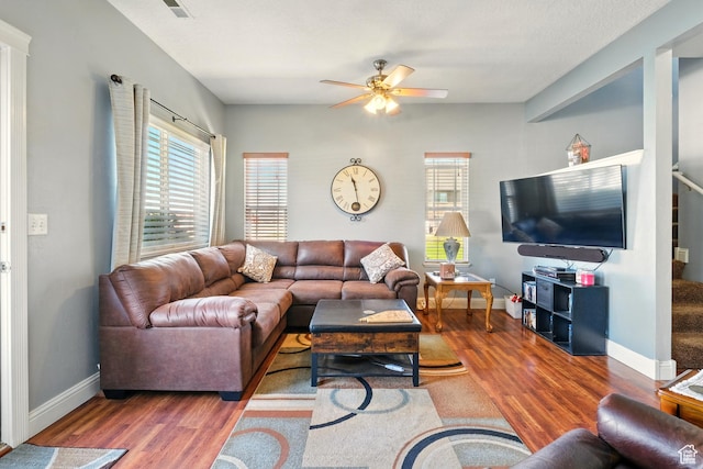 1587 N 565 W Unit 101, Logan, UT 84341 - living room featuring wood finished floors, a ceiling fan, and baseboards