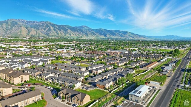 1587 N 565 W Unit 101, Logan, UT 84341 - aerial overview of property's location with a mountain backdrop and nearby suburban area