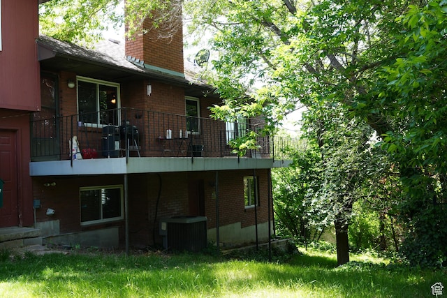 314 W 1700 S, Orem, UT 84058 - rear view of house with central air condition unit, a chimney, and brick siding