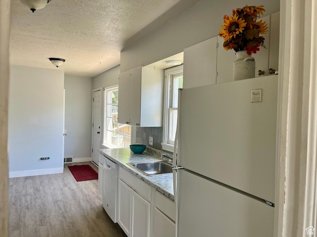 123 S State St, Salina, UT 84654 - kitchen with white appliances, wood finished floors, white cabinetry, a textured ceiling, and baseboards