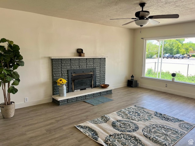123 S State St, Salina, UT 84654 - living room featuring wood finished floors, a ceiling fan, baseboards, and a textured ceiling