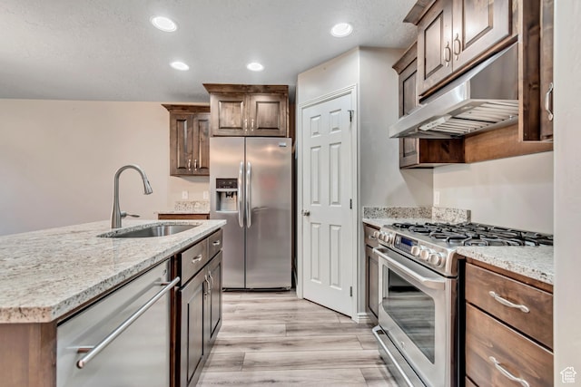 1909 E 280 S, Spanish Fork, UT 84660 - kitchen with appliances with stainless steel finishes, a sink, light wood-type flooring, under cabinet range hood, and light stone counters