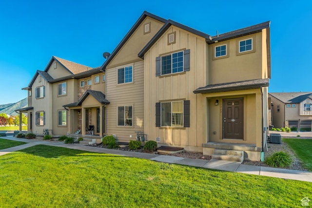 1909 E 280 S, Spanish Fork, UT 84660 - townhome / multi-family property with board and batten siding, a front yard, and central air condition unit