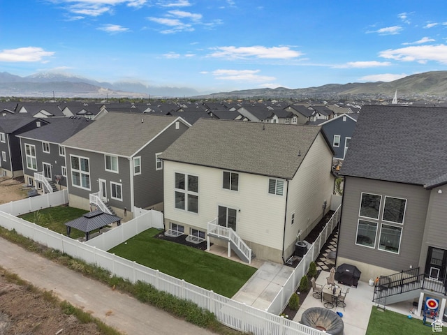 6636 W Ipswitch Way S, Herriman, UT 84096 - rear view of house with a residential view, a mountain view, a patio area, and roof with shingles