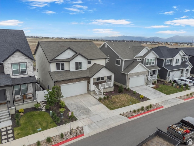 6636 W Ipswitch Way S, Herriman, UT 84096 - view of front of home featuring a residential view, concrete driveway, an attached garage, a porch, and a mountain view
