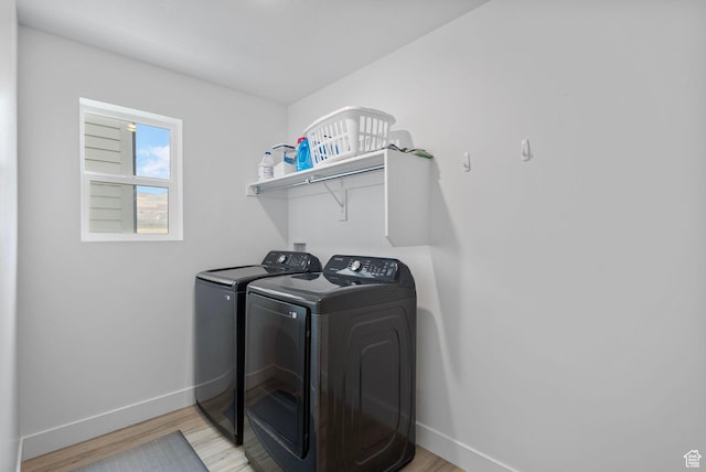 6636 W Ipswitch Way S, Herriman, UT 84096 - washroom featuring independent washer and dryer, baseboards, and light wood finished floors