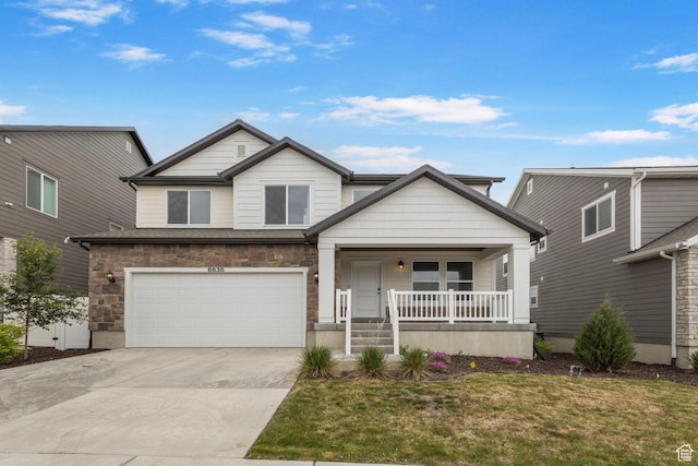 6636 W Ipswitch Way S, Herriman, UT 84096 - view of front of house with a porch, concrete driveway, an attached garage, a front yard, and stone siding