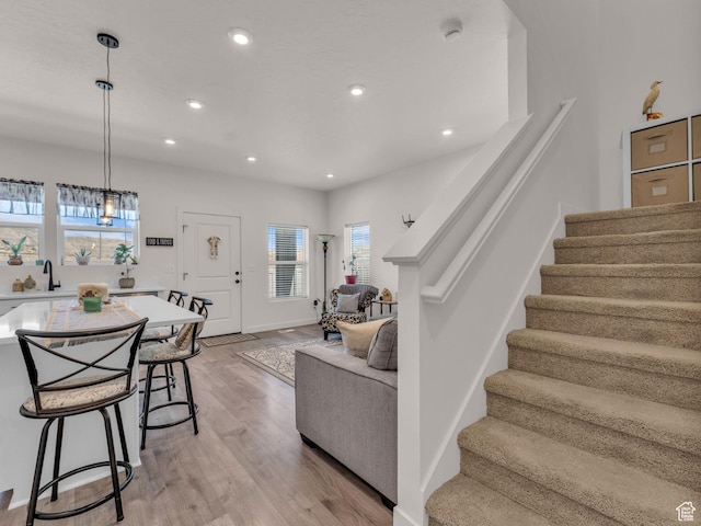 4423 E Longleaf Ln, Eagle Mountain, UT 84005 - living room featuring stairway, light wood-style flooring, and recessed lighting