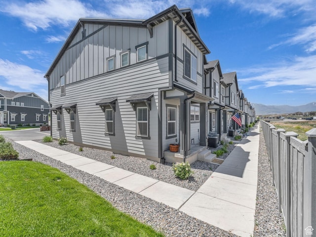 4423 E Longleaf Ln, Eagle Mountain, UT 84005 - view of side of home featuring board and batten siding, a residential view, cooling unit, and a mountain view
