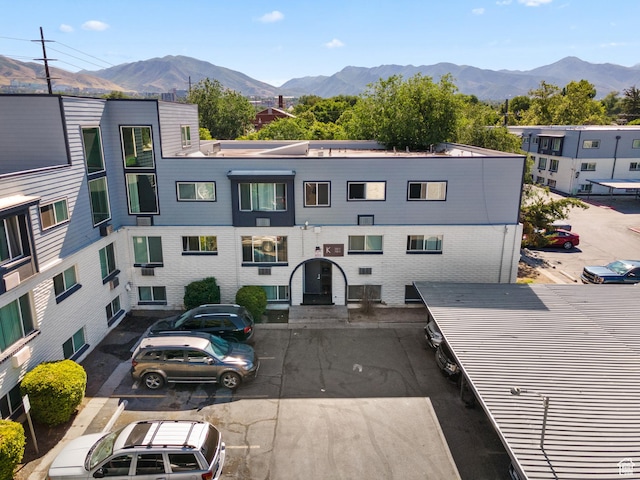 350 E 700 S Unit K102, Salt Lake City, UT 84111 - view of building exterior with uncovered parking and a mountain view