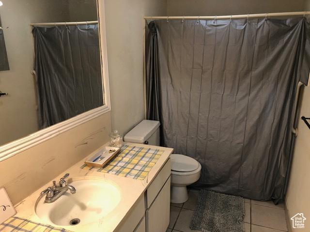 350 E 700 S Unit K102, Salt Lake City, UT 84111 - bathroom featuring toilet, vanity, tile patterned flooring, and a shower with curtain