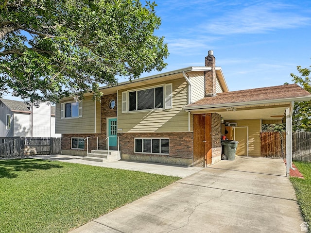 485 W Cottonwood Ln, Ferron, UT 84523 - view of front of house featuring a chimney, concrete driveway, brick siding, and an attached carport