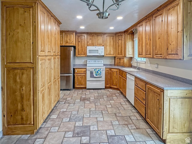 485 W Cottonwood Ln, Ferron, UT 84523 - kitchen with white appliances, a sink, stone finish floors, a chandelier, and brown cabinetry