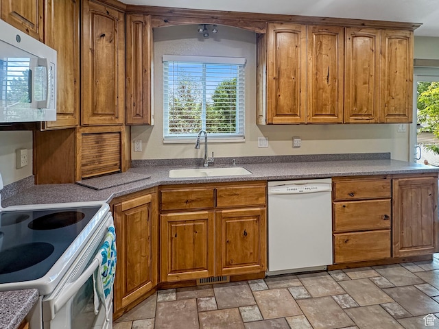 485 W Cottonwood Ln, Ferron, UT 84523 - kitchen featuring white appliances, a sink, brown cabinetry, and stone finish floors