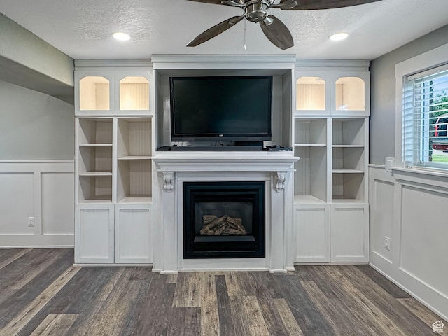 485 W Cottonwood Ln, Ferron, UT 84523 - unfurnished living room with a decorative wall, a fireplace, a ceiling fan, dark wood finished floors, and a textured ceiling