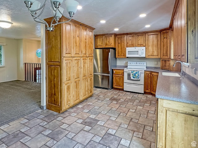 485 W Cottonwood Ln, Ferron, UT 84523 - kitchen with white appliances, a sink, brown cabinets, a chandelier, and recessed lighting