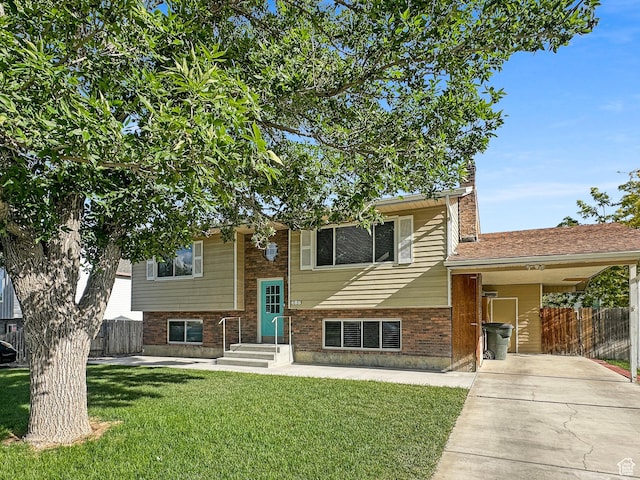 485 W Cottonwood Ln, Ferron, UT 84523 - view of front facade with driveway, an attached carport, brick siding, and a chimney