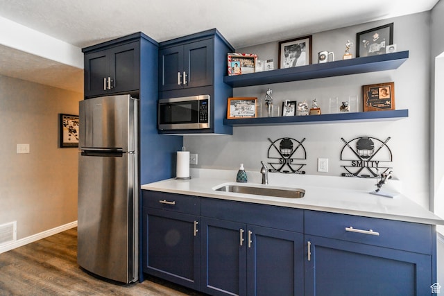 5151 Case Mountain Rd, West Jordan, UT 84081 - kitchen with appliances with stainless steel finishes, a sink, open shelves, and blue cabinetry