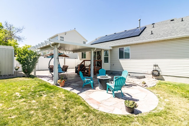 5151 Case Mountain Rd, West Jordan, UT 84081 - back of house with an outdoor fire pit, a patio area, and roof mounted solar panels