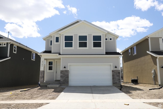 3705 N Janie St Unit 1016, Eagle Mountain, UT 84005 - view of front of property with stone siding, an attached garage, and concrete driveway