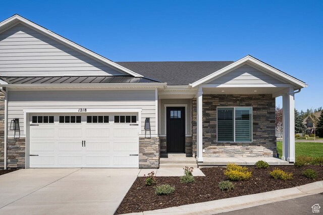 1252 W 770 S Unit 104, Heber City, UT 84032 - view of front of house with stone siding, driveway, an attached garage, and a standing seam roof
