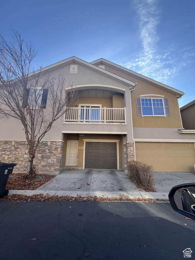 1593 W 110 N Unit 4, Pleasant Grove, UT 84062 - view of front of property with stucco siding, an attached garage, a balcony, and stone siding