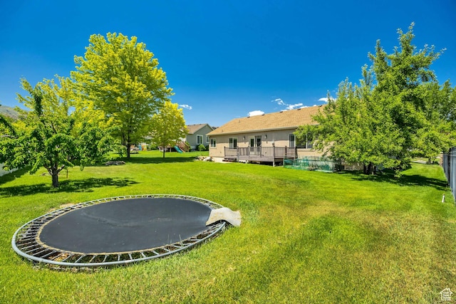 67 E Summer Pl S, Saratoga Springs, UT 84045 - view of grassy yard featuring a trampoline and a deck