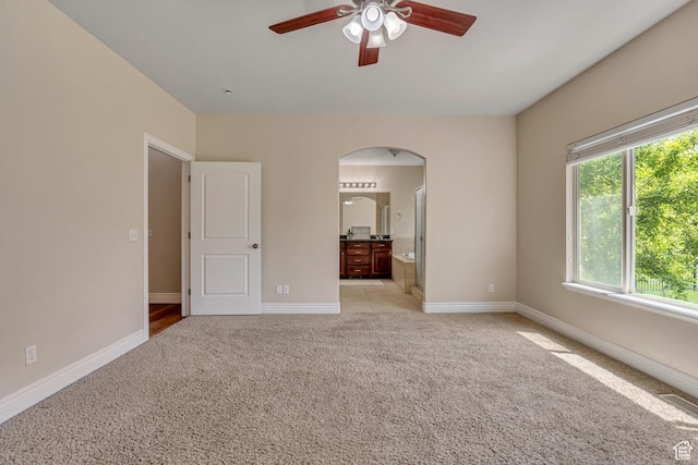 67 E Summer Pl S, Saratoga Springs, UT 84045 - unfurnished bedroom with arched walkways, light colored carpet, baseboards, and ensuite bathroom