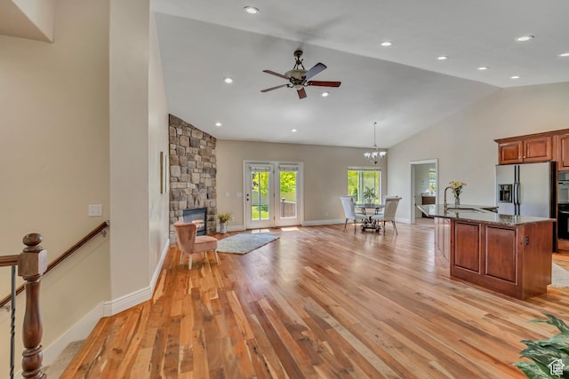 67 E Summer Pl S, Saratoga Springs, UT 84045 - kitchen with stainless steel fridge with ice dispenser, light wood-style floors, dark stone counters, a ceiling fan, and high vaulted ceiling