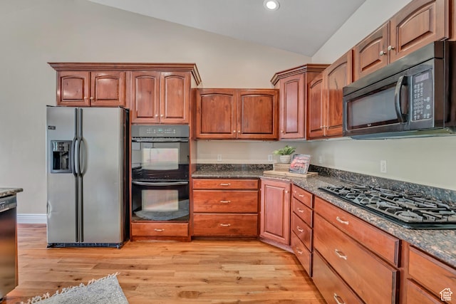 67 E Summer Pl S, Saratoga Springs, UT 84045 - kitchen with black appliances, vaulted ceiling, light wood-type flooring, dark stone countertops, and brown cabinetry