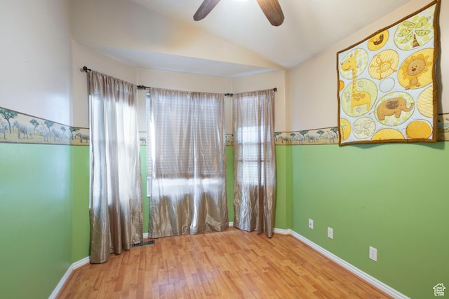 3601 S Truth Ln, Magna, UT 84044 - empty room with lofted ceiling, a ceiling fan, wood finished floors, and baseboards