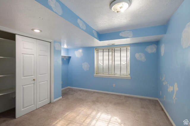 3601 S Truth Ln, Magna, UT 84044 - unfurnished bedroom with carpet flooring, a textured ceiling, a closet, and baseboards