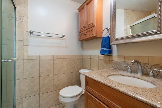 3601 S Truth Ln, Magna, UT 84044 - full bathroom with vanity, tile walls, toilet, a tile shower, and wainscoting