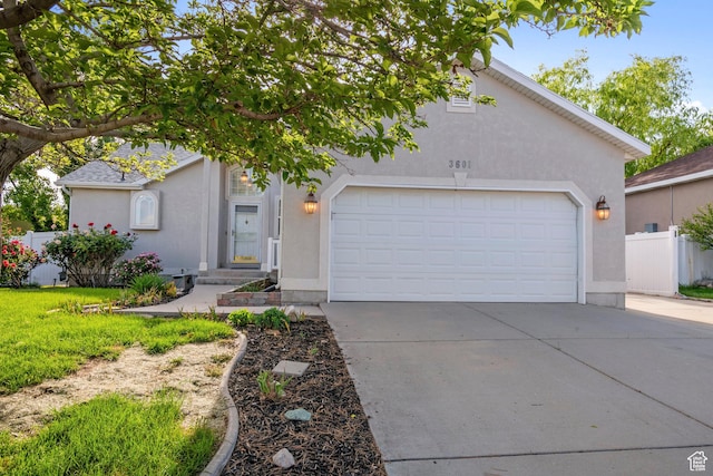 3601 S Truth Ln, Magna, UT 84044 - view of front of house with driveway, stucco siding, and an attached garage