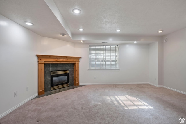 3601 S Truth Ln, Magna, UT 84044 - unfurnished living room featuring carpet floors, recessed lighting, a tile fireplace, and baseboards