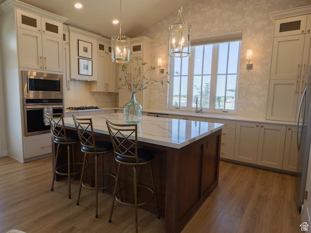 4817 W 50 S, West Point, UT 84015 - kitchen with stainless steel appliances, wood finished floors, a chandelier, a center island, and white cabinets