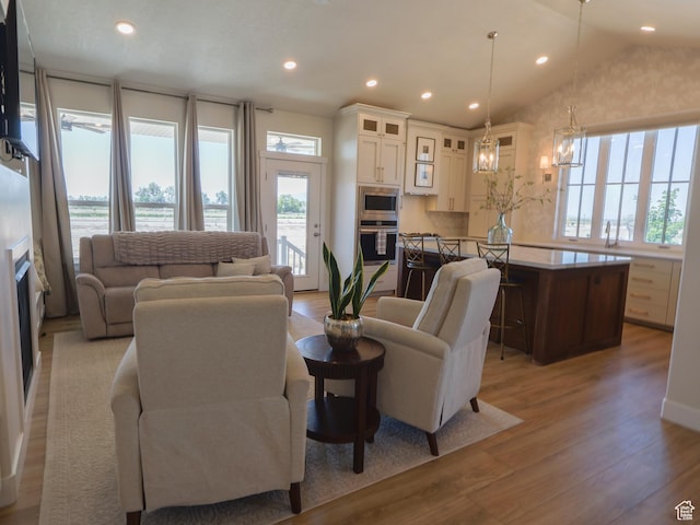 4817 W 50 S, West Point, UT 84015 - living room with light wood-style floors, plenty of natural light, a chandelier, recessed lighting, and vaulted ceiling