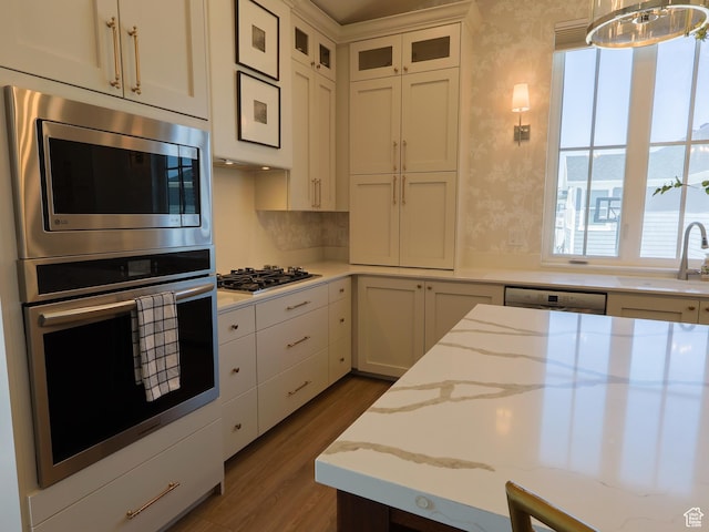 4817 W 50 S, West Point, UT 84015 - kitchen with stainless steel appliances, a sink, wallpapered walls, wood finished floors, and white cabinetry
